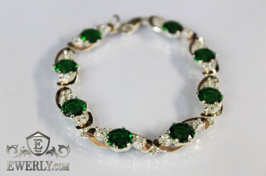Купить женский серебряный браслет с зелёными камнями и вставками золота